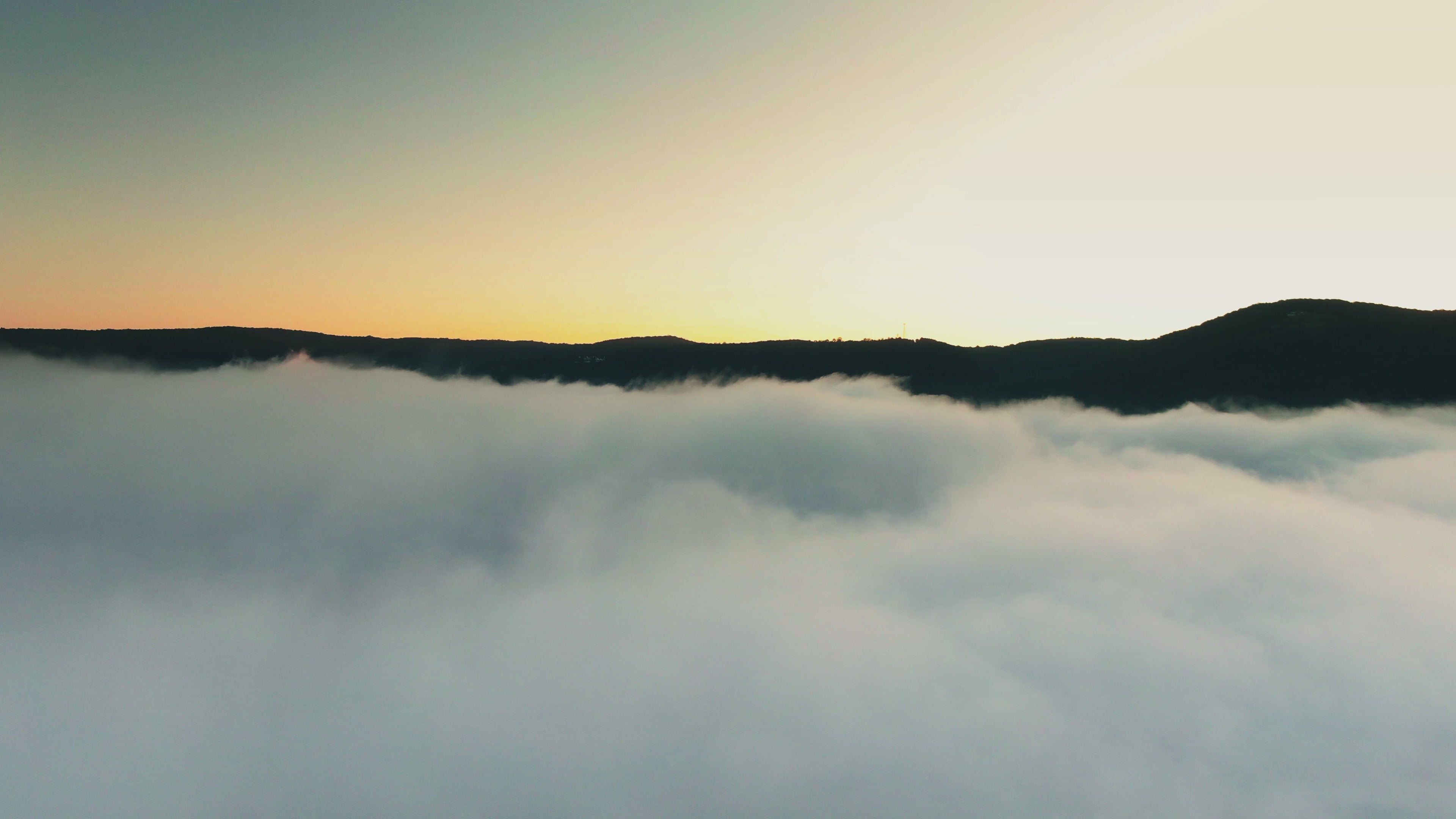 Khansa sunrise slow motion push over misty mountains of Ecuador.